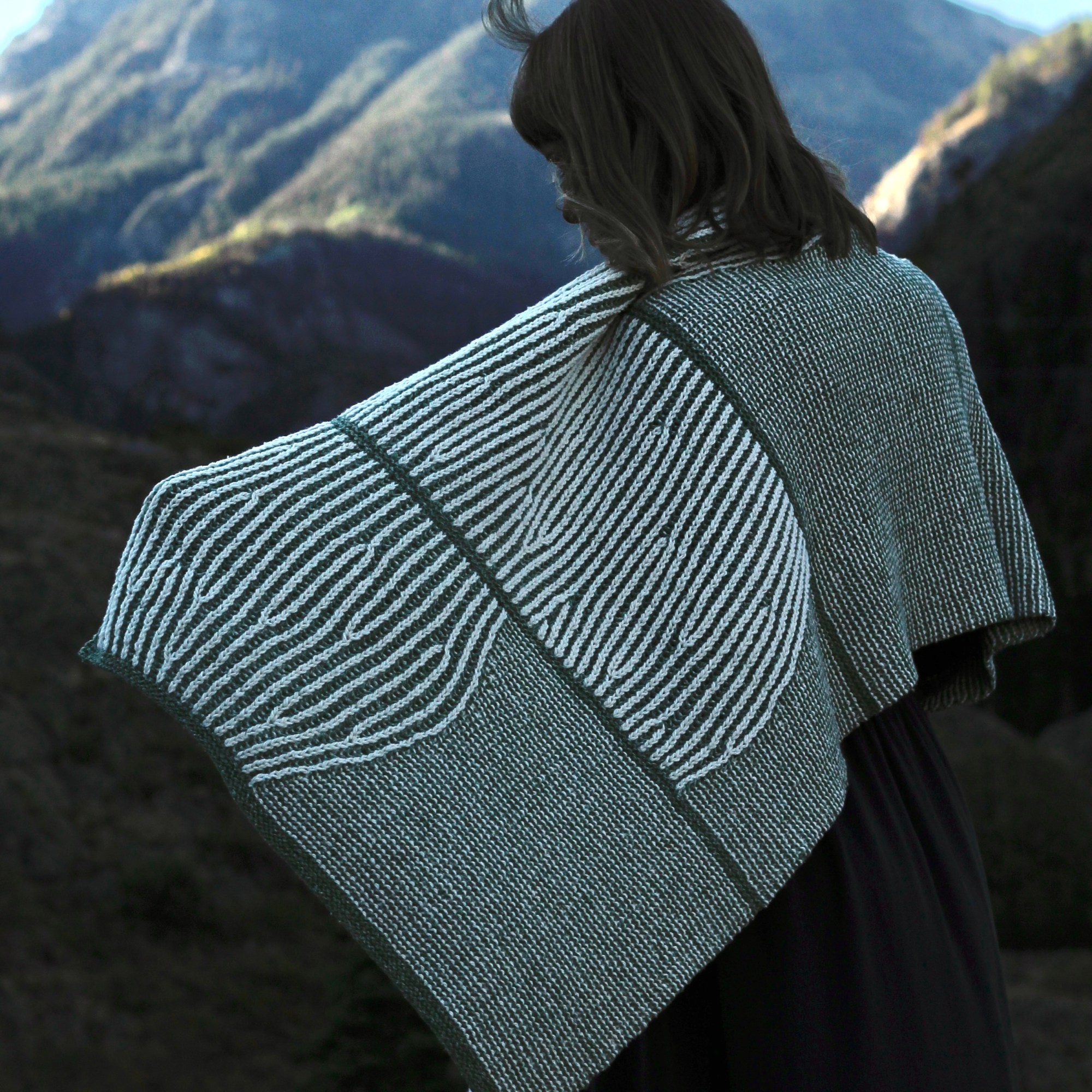 Roofalanche shawl with single arm outstretched and Mt Abrams in the background.